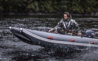 A man riding a tactician inflatable boat