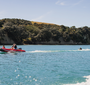 people riding an inflatable boat