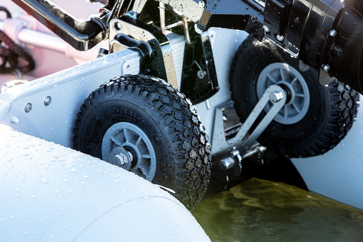 QuickLok Dinghy Wheels sit in behind the transom and don't interfere with the outboard