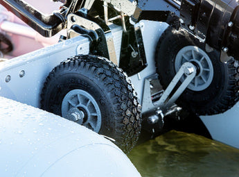 QuickLok Dinghy Wheels sit in behind the transom and don't interfere with the outboard